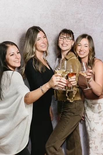 A group of friends cheering with glasses raised